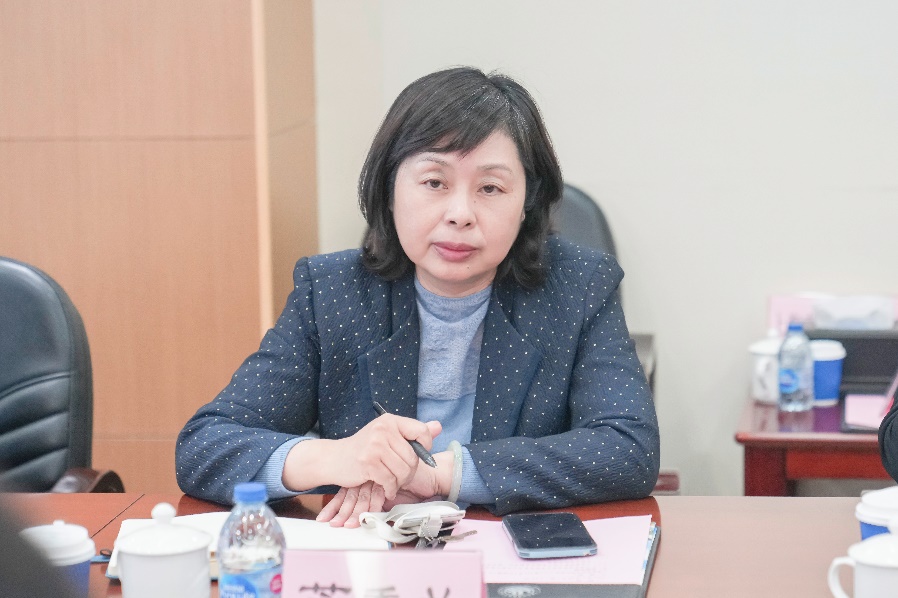 桌子前坐着穿蓝色衣服的人中度可信度描述已自动生成